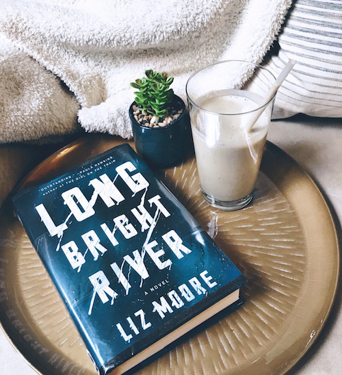 Original photo of a copy of Long Bright River on a tray next to a succulent and a smoothie