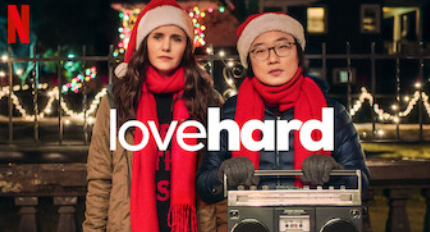 Best Christmas Movies of 2021: Lovehard. Photo of Nina Dobrev and Jimmy O. Yang in Santa hats