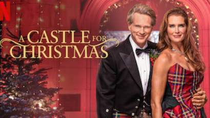 Best Christmas Movies of 2021: A Castle for Christmas. Photo of Brooke Shields and Cary Elwes in front of a Christmas tree.