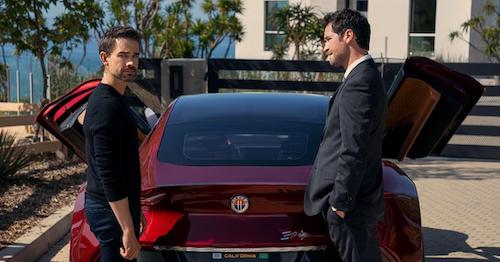 The Lincoln Lawyer on Netflix: new series character Trevor Elliot, a software designer, taks to Mickey in front of a red sport car in Malibu.