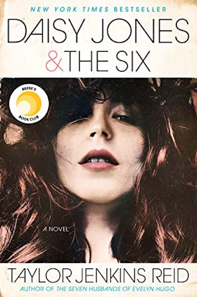 a photo of the cover of Daisy Jones & the Six by Taylor Jenkins Reid. Very close up photo of a young woman with dark wavy hair