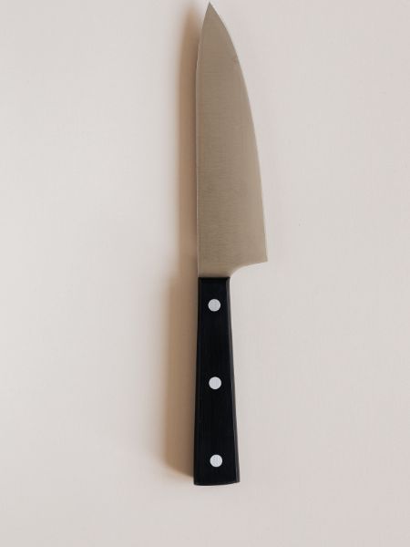 A photo of a chef's knife on a white background