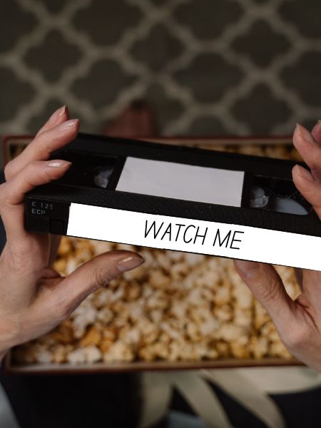 Spoiler Discussion Post for Daisy Darker: the book features VHS tapes with messages on them. Photo of a woman holding a tape that says "watch me."