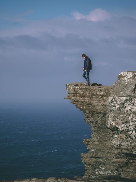 Spoiler Discussion Post for Daisy Darker: photo of a man standing on a cliff over the sea 
