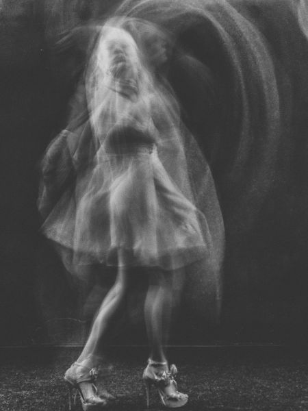 Spoiler Discussion Post for Daisy Darker: this book takes a turn into the supernatural. Photo of a ghostly woman in a dress and heels.