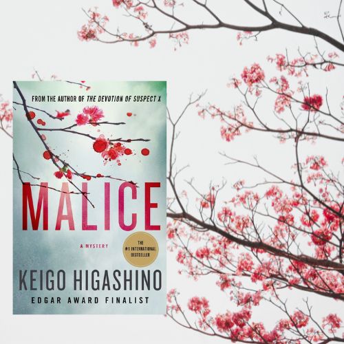 Photo of Malice by Keigo Higashino next to a branch of cherry blossoms