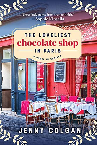 Cover of the Loveliest Chocolate Shop in Paris by Jenny Colgan. A photo of a Parisian shop with a table and chairs outside.