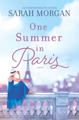 Cover of One Summer in Paris by Sarah Morgan. Photo of a woman in a blue dress and sun hat perched on a tone railing looking at the Eiffel tower.