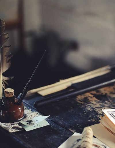 Writing desk with an ink pot, a quill pen and some papers.