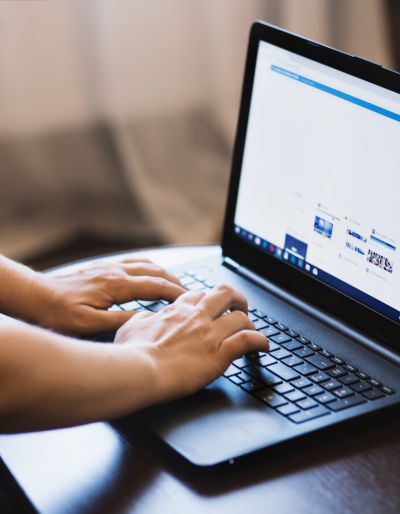 Photo of a person typing on a laptop computer.