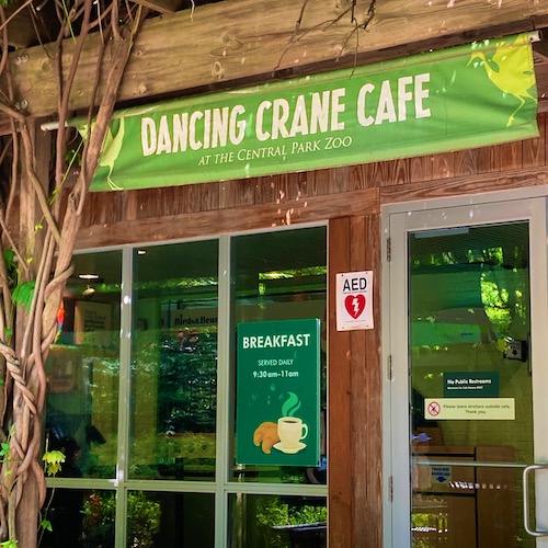 Photo of the Dancing Frog Cafe at the Zoo in Central Park. Photo by Jen Ryland LLC. Photo shows the sign on the outside the cafe.