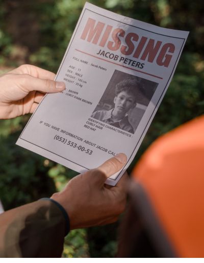 Hands holding a missing persons flyer