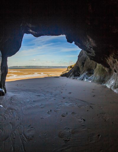 Cave at the ocean. The photo is taken inside the cave looking out toward the sea.