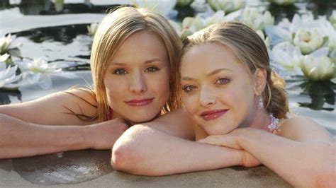 A photo of Lily Kane and Veronica Mars learning on the edge of a swimming pool.