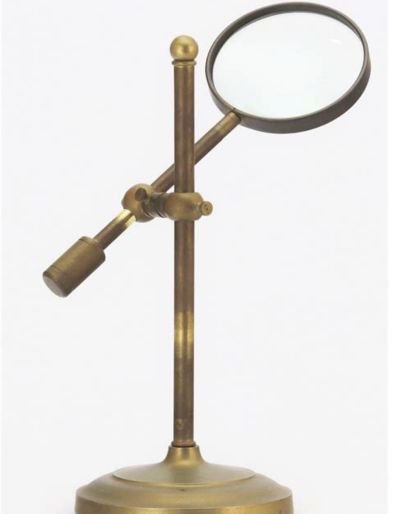 A bronze magnifying glass on a stand