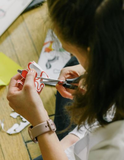 Woman cutting a piece of paper