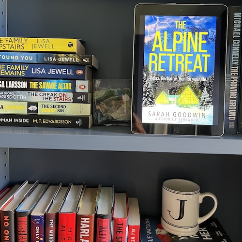 The cover of The Alpine Retreat by Sarah Goodwin on a shelf with books