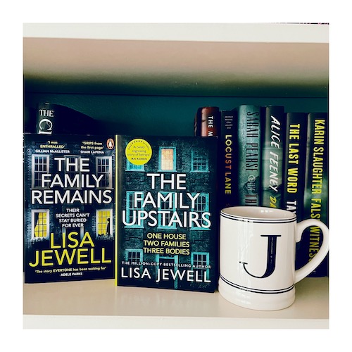 Original photo of The Family Remains and The Family Upstairs next to a J mug.
