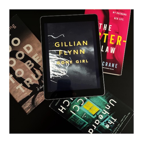 A copy of Gone Girl by Gillian Flynn with other domestic thrillers on a table.