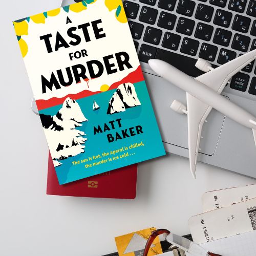 Copy of A Taste for murder on a laptop with a toy airplane and travel documents