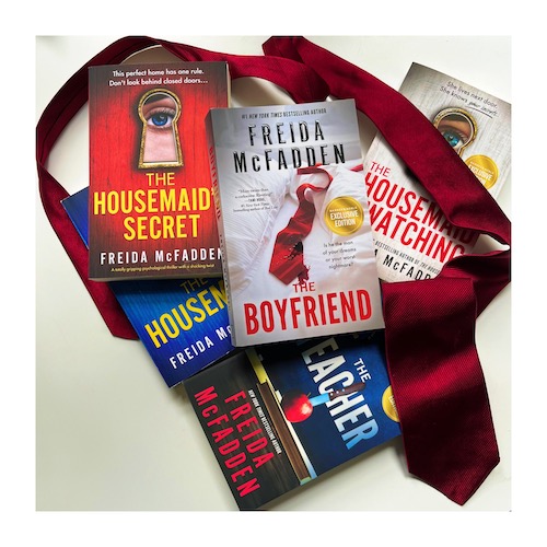 Original photo of The Housemaid series and The Teacher piled up with The Boyfriend on top and a red men's tie coiled around the books