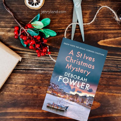 A copy of A St ives Christmas Mystery next to a sprig of holly and dried fruit
