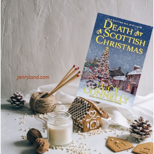 Copy of Death at a Scottish Christmas on a table near pinecones, a gingerbread house and candles
