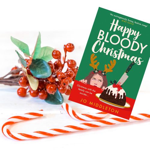 A copy of Happy Bloody Christmas with candy canes and holly