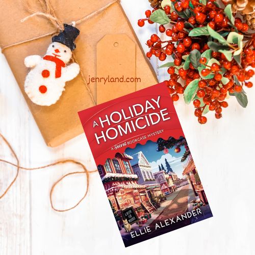 Copy of a Holiday Homicide on a table next to wrapping paper, a snowman ornament, and a sprig of holly
