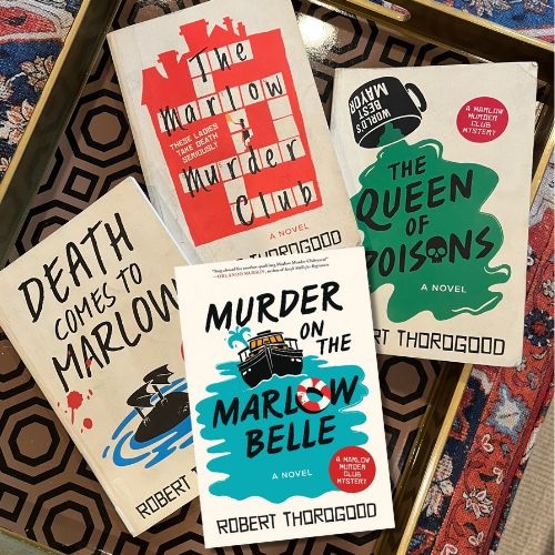 Original photo of four Marlow Murder club books on a patterned tray