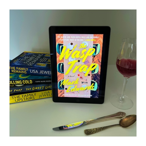 Original photo of The Wasp Trap on a bookshelf with other yellow books, a glass ov wine and silverware