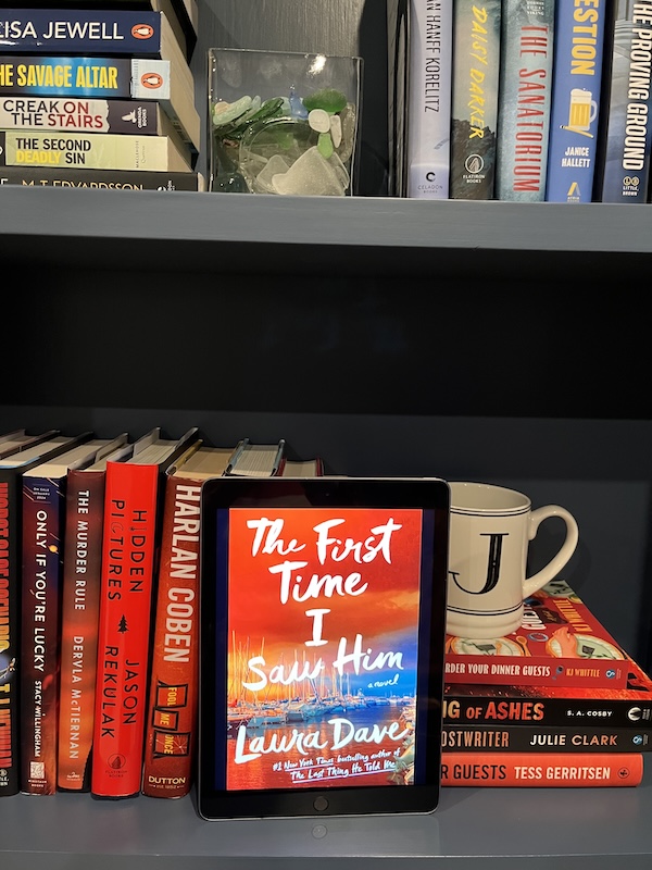 Copy of The First Time I Saw Him on a shelf with other red books