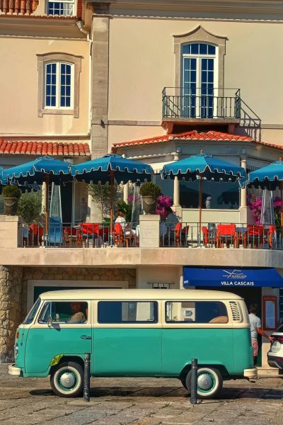 VW van parked in front of a street in a small holiday town