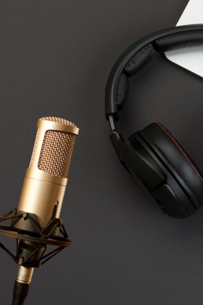 Gold podcaster mice and black headphones