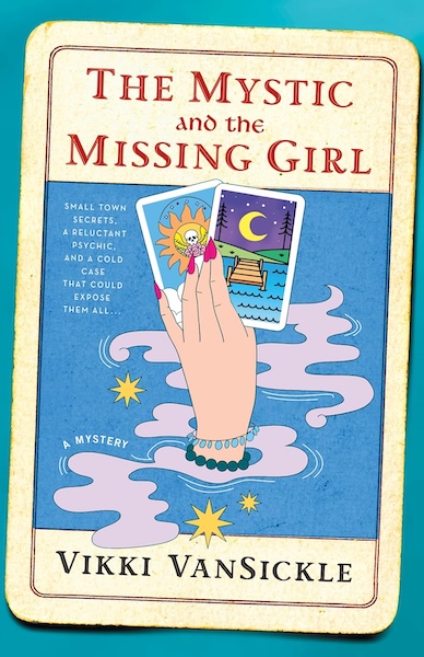 Cover of the Mystic and The Missing Girl which shows a hand holding two tarot cards