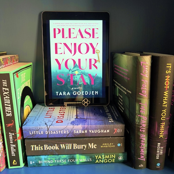 Original photo of Please Enjoy Your Stay on a stack of books